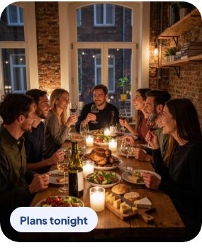 Friends sharing dinner at a candlelit table